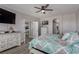 Inviting bedroom featuring a large bed, modern decor, and a view into the ensuite bathroom at 140 Rolling Cove Ave, Henderson, NV 89011