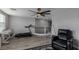 Upstairs bonus room with a ceiling fan, wood floors, large windows, and neutral walls at 140 Rolling Cove Ave, Henderson, NV 89011