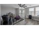 Upstairs bonus room with a ceiling fan, wood floors, large windows, and neutral walls at 140 Rolling Cove Ave, Henderson, NV 89011