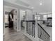 Upstairs hallway with wood floors, iron railing, and views to a workout room and secondary bathroom at 140 Rolling Cove Ave, Henderson, NV 89011