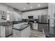 Spacious kitchen with white cabinetry, stainless steel appliances, stylish backsplash, and granite countertops at 140 Rolling Cove Ave, Henderson, NV 89011