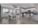 Bright, open kitchen featuring stainless steel appliances, island, and adjacent dining area with large windows at 140 Rolling Cove Ave, Henderson, NV 89011