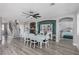 Open-concept living area with a dining table, stairs, and a fireplace, with a glimpse into the main bedroom at 140 Rolling Cove Ave, Henderson, NV 89011