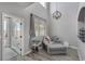 Bright living room featuring neutral tones, a comfortable grey sectional, a modern chandelier, and wood-look flooring at 140 Rolling Cove Ave, Henderson, NV 89011