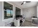 Well-lit home office with modern desk setup and views from multiple windows at 140 Rolling Cove Ave, Henderson, NV 89011