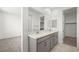Clean bathroom with double sinks, gray cabinets, and large mirrors, offering a modern aesthetic at 1452 Melodic Lark Ln, Las Vegas, NV 89138