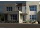 Modern two-story home with a neutral color palette, clean lines, and desert landscaping in the front yard at 1452 Melodic Lark Ln, Las Vegas, NV 89138