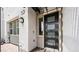Modern front door with glass inserts and stylish exterior lighting at 1452 Melodic Lark Ln, Las Vegas, NV 89138