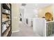 Bright hallway with decorative woven baskets, sleek railing, and access to other rooms at 1452 Melodic Lark Ln, Las Vegas, NV 89138