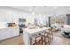 Open concept kitchen with stainless appliances, a center island, and seamless flow into the living space at 1452 Melodic Lark Ln, Las Vegas, NV 89138