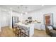 Modern kitchen with stainless steel appliances, white cabinetry, and a center island with seating at 1452 Melodic Lark Ln, Las Vegas, NV 89138