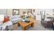 Open-concept living room featuring a comfortable sofa and an accent chair near the kitchen at 1452 Melodic Lark Ln, Las Vegas, NV 89138
