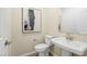This powder room has a pedestal sink with modern fixtures, neutral paint, and tile flooring at 1452 Melodic Lark Ln, Las Vegas, NV 89138