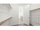 Spacious walk-in closet with built-in shelving and hanging rods for optimal storage at 1452 Melodic Lark Ln, Las Vegas, NV 89138