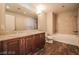 Bathroom featuring double sinks, granite counters, a bathtub and a separate shower at 150 N Las Vegas Blvd # 804, Las Vegas, NV 89101