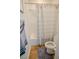 Clean bathroom features a shower-tub combo with modern gray striped shower curtain at 1608 Rock Ridge Pl, North Las Vegas, NV 89084