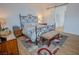 Well-lit bedroom with a stylish bed frame, wood flooring, a barn door and a decorative rug at 1608 Rock Ridge Pl, North Las Vegas, NV 89084