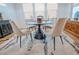 Bright dining room with modern furnishings, including a round table, upholstered chairs, and stylish decor at 1608 Rock Ridge Pl, North Las Vegas, NV 89084