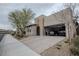 Attractive stucco home with a two-car garage, desert landscaping, and a brick-paved driveway at 1608 Rock Ridge Pl, North Las Vegas, NV 89084