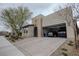 Attractive stucco home with a two-car garage, desert landscaping, and a brick-paved driveway at 1608 Rock Ridge Pl, North Las Vegas, NV 89084