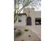 Inviting home exterior with an arched front door, desert landscaping, and a brick-paved driveway at 1608 Rock Ridge Pl, North Las Vegas, NV 89084