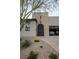 Inviting home exterior with an arched front door, desert landscaping, and a brick-paved driveway at 1608 Rock Ridge Pl, North Las Vegas, NV 89084