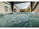 Inviting hot tub with pergola and privacy drapes creates a relaxing outdoor oasis at 1608 Rock Ridge Pl, North Las Vegas, NV 89084