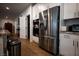 Stainless steel refrigerator and appliances are built into cabinets, providing a sleek and modern kitchen design at 1608 Rock Ridge Pl, North Las Vegas, NV 89084