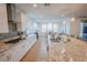 Modern kitchen with white cabinets, granite countertops, a large island, and stainless steel appliances at 1608 Rock Ridge Pl, North Las Vegas, NV 89084