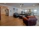 Expansive living room with a black leather sectional sofa, hardwood floors, and an open layout at 1608 Rock Ridge Pl, North Las Vegas, NV 89084