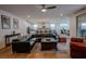 Open-concept living room showcasing a spacious seating area, hardwood floors, and access to the kitchen at 1608 Rock Ridge Pl, North Las Vegas, NV 89084