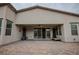 A covered patio features a brick-paved floor and ceiling fan, providing a comfortable outdoor living space at 1608 Rock Ridge Pl, North Las Vegas, NV 89084