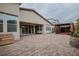 Spacious outdoor patio with a brick surface, shaded seating area, and a well-maintained backyard at 1608 Rock Ridge Pl, North Las Vegas, NV 89084
