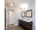 This bathroom features double vanities with dark wood cabinets and modern fixtures and lighting at 1700 Ivanhoe Way, Las Vegas, NV 89102