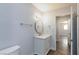 Well-lit bathroom with a vanity sink, a mirror, and access to a hallway at 1700 Ivanhoe Way, Las Vegas, NV 89102