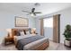 Bright bedroom featuring soft carpeting, side tables with lamps, and is illuminated by natural light from a window at 1700 Ivanhoe Way, Las Vegas, NV 89102