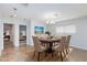 Chic dining room with modern chandelier, a nearby bedroom, and seating for six at 1700 Ivanhoe Way, Las Vegas, NV 89102