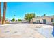 A wide driveway leads to this cozy home, with a tree and the Stratosphere in the background at 1700 Ivanhoe Way, Las Vegas, NV 89102