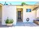 A welcoming front entrance with decorative potted plants and a classic black door is featured at 1700 Ivanhoe Way, Las Vegas, NV 89102