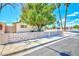 This charming home features a decorative concrete fence and mature trees, creating a welcoming curb appeal at 1700 Ivanhoe Way, Las Vegas, NV 89102