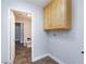 Well-organized laundry area with overhead cabinets and adjacent half bathroom at 1700 Ivanhoe Way, Las Vegas, NV 89102