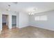 Spacious room with tile floors, a hanging chandelier, and natural light from a large window at 1700 Ivanhoe Way, Las Vegas, NV 89102