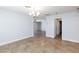 Large room with tile flooring, a chandelier, and an open doorway to other rooms in the home at 1700 Ivanhoe Way, Las Vegas, NV 89102