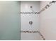Close-up of shower with decorative tile accents, shower head, and a glass wall panel at 1700 Ivanhoe Way, Las Vegas, NV 89102