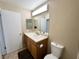 Neutral bathroom featuring wood vanity, white sink, and ample lighting at 2072 Mesquite Ln # 102, Laughlin, NV 89029