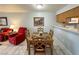 A charming dining area with wood table sits adjacent to the comfortable living room with tile flooring at 2072 Mesquite Ln # 102, Laughlin, NV 89029