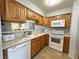 Well-lit kitchen featuring wood cabinets, tile floor, and white appliances at 2072 Mesquite Ln # 102, Laughlin, NV 89029