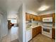 Bright kitchen featuring wood cabinets and white appliances at 2072 Mesquite Ln # 102, Laughlin, NV 89029