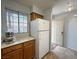 Kitchen with white appliances, tile floor, and access to entry door at 2072 Mesquite Ln # 102, Laughlin, NV 89029