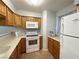 Bright kitchen with white appliances, wood cabinets and view of breakfast bar at 2072 Mesquite Ln # 102, Laughlin, NV 89029